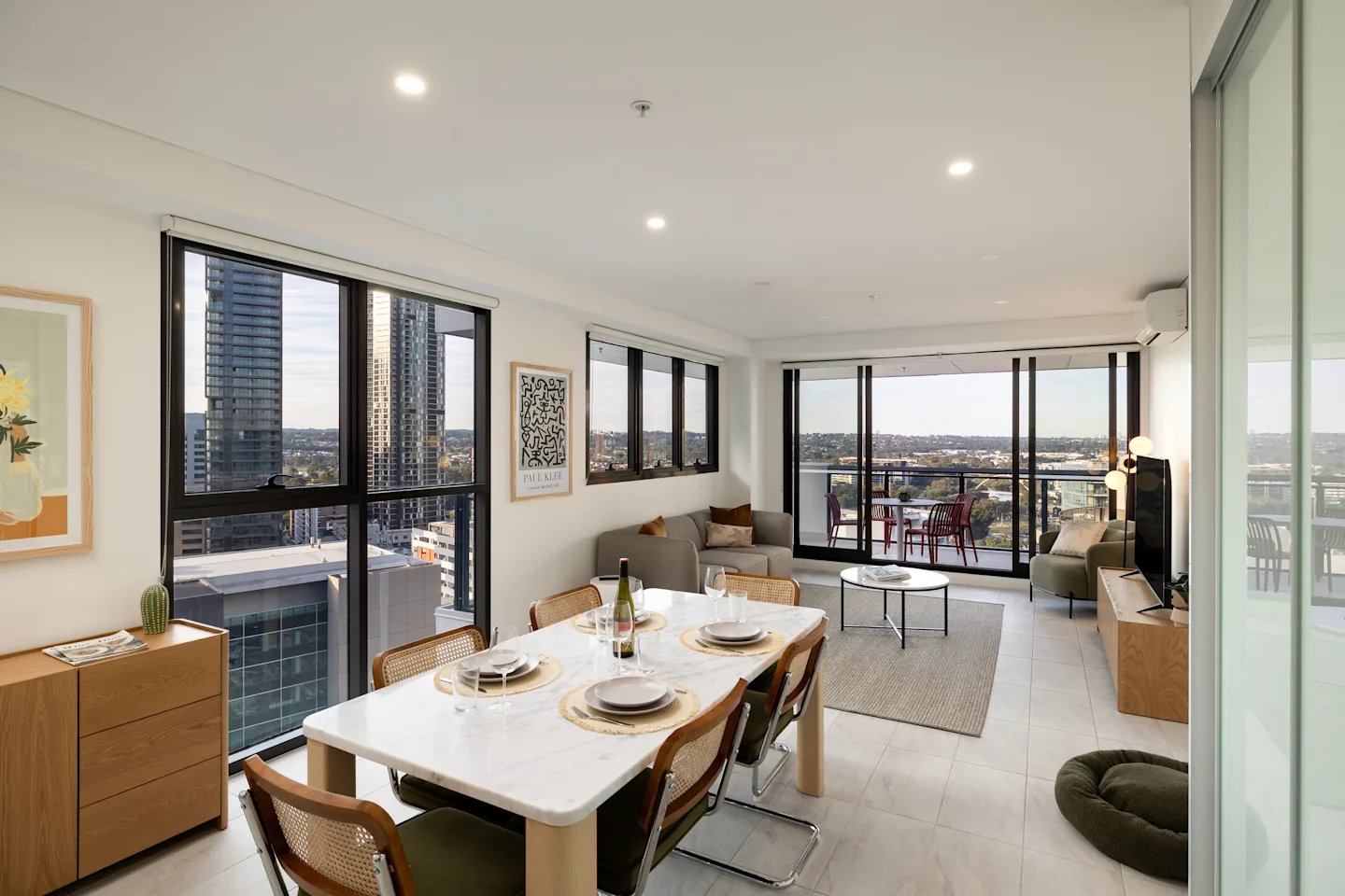 Dining table sofa balcony chairs living room exterior at UKO Parramatta Central in Sydney Student Accommodation