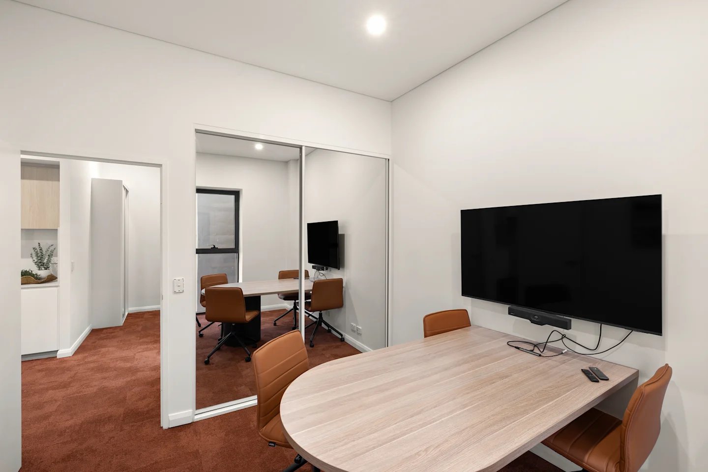 Two oval tables and brown chairs study area at UKO Parramatta Central in Sydney Student Accommodation