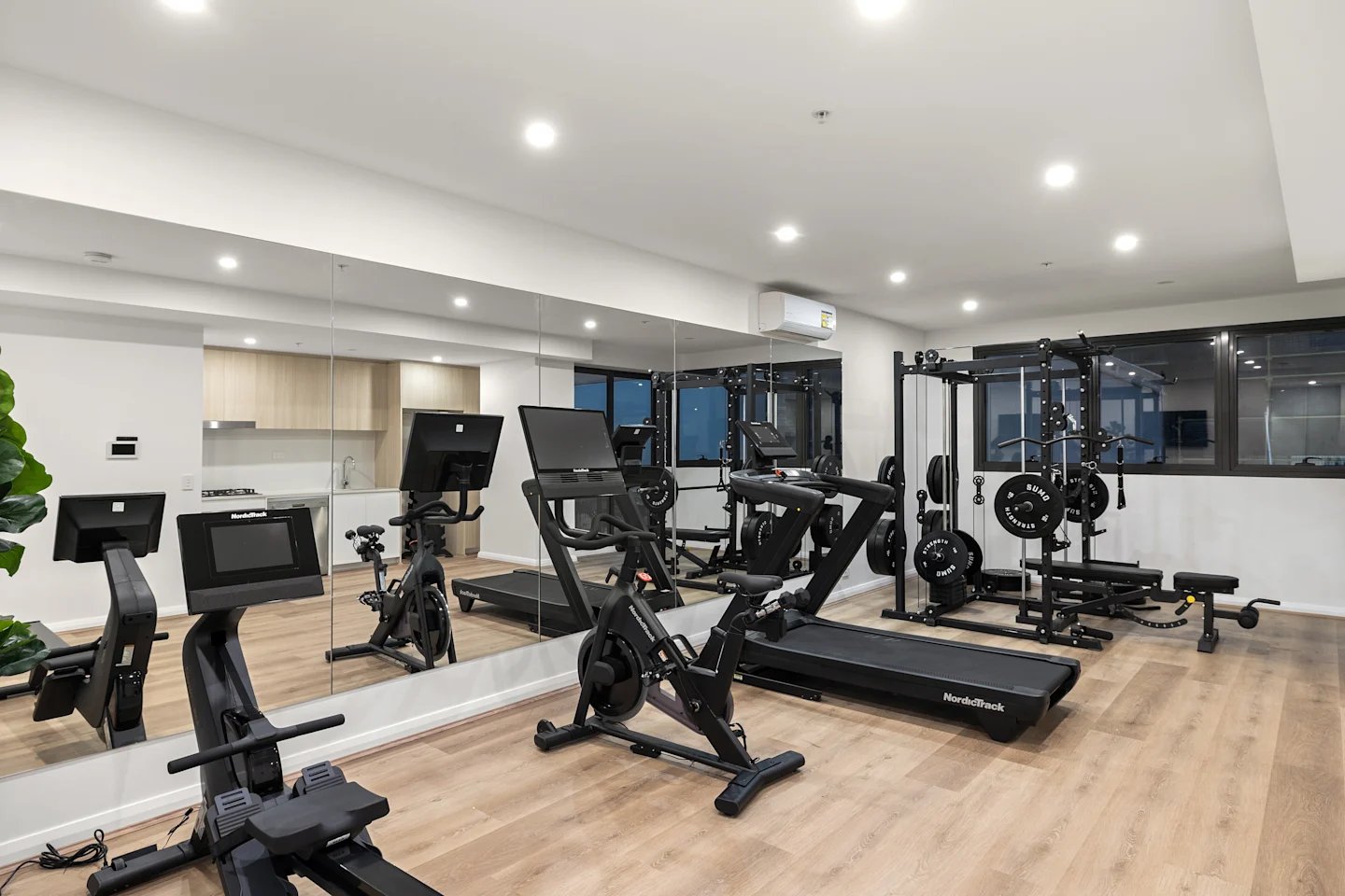 Gym equipment includes treadmills bikes and weights gym area at UKO Parramatta Central in Sydney Student Accommodation