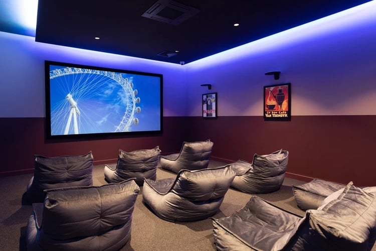 Bean bag chairs facing large screen movie room at Hayloft Point in London Student Accommodation