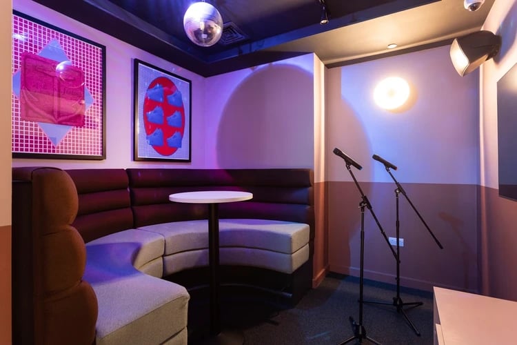 Booth seating with microphones and art playing area at Hayloft Point in London Student Accommodation