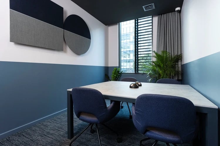 Table chairs plant window wall art meeting room at Hayloft Point in London Student Accommodation