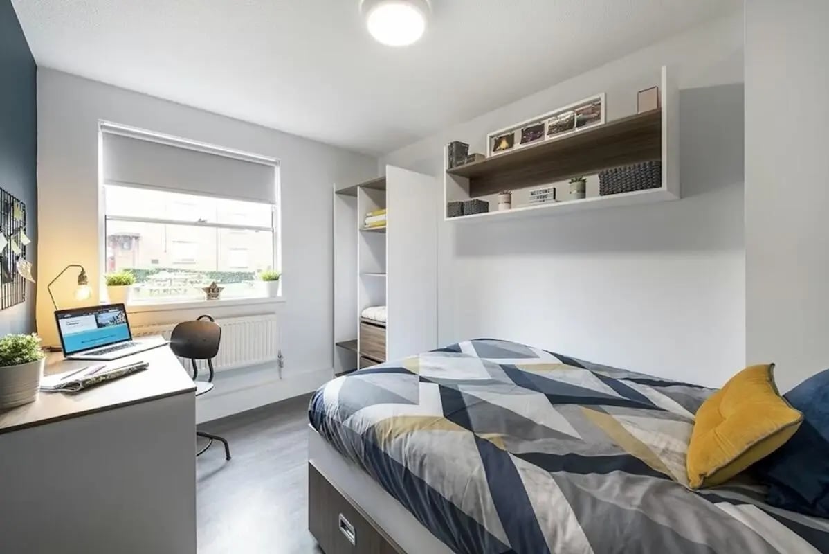 Desk laptop chair shelves bed bedroom at Regents Court in Leicester Student Accommodation