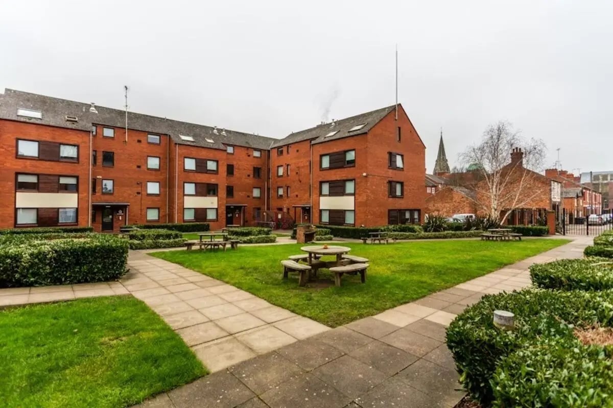 Brick building with courtyard picnic tables exterior at Regents Court in Leicester Student Accommodation
