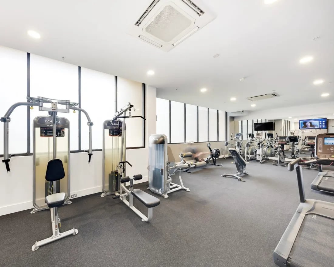 Gym equipment and treadmills modern fitness area at Belong Waterloo in Sydney Student Accommodation