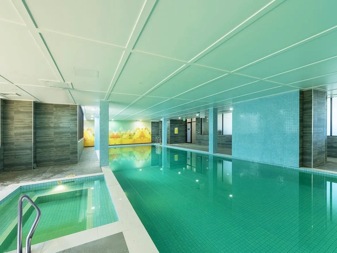 Indoor swimming pool with steps and mural Image Type swimming pool at Belong Waterloo in Sydney Student Accommodation