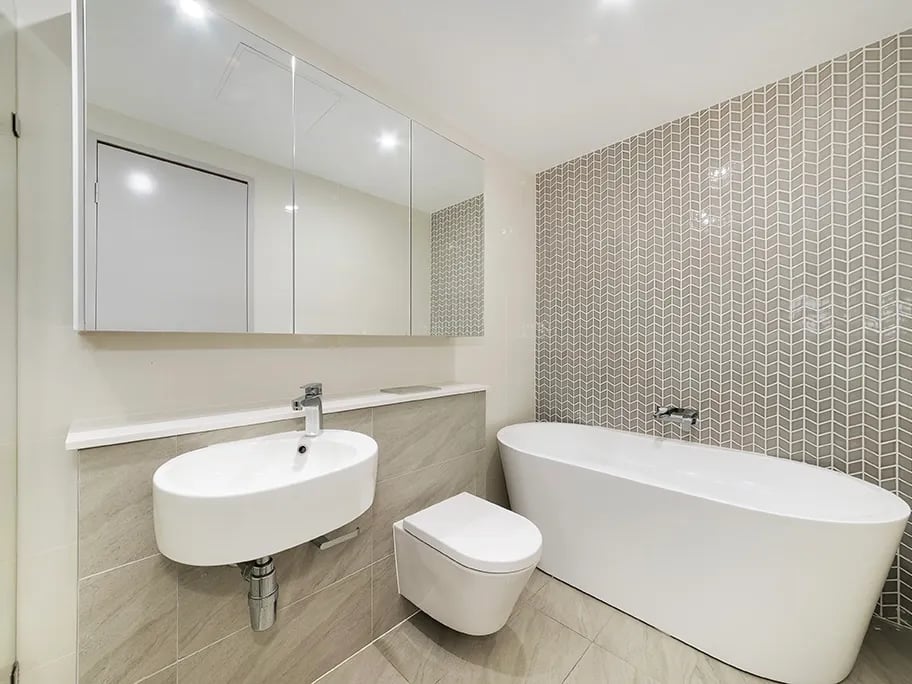 Modern bathroom with bathtub toilet and vanity bathroom at Belong Waterloo in Sydney Student Accommodation