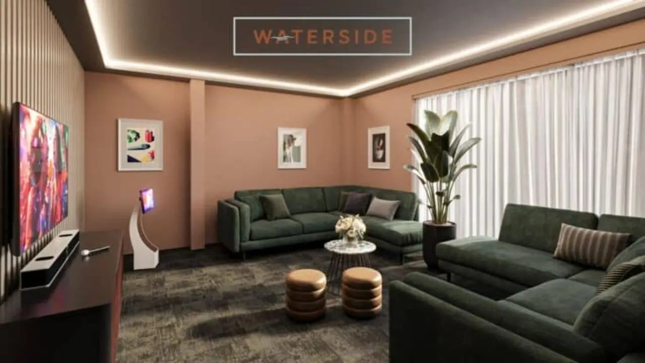 Green couches TV and plants living room at Waterside in Bristol Student Accommodation