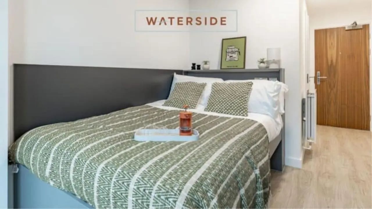 Bed with green blanket pillows and tray Bedroom at Waterside in Bristol Student Accommodation