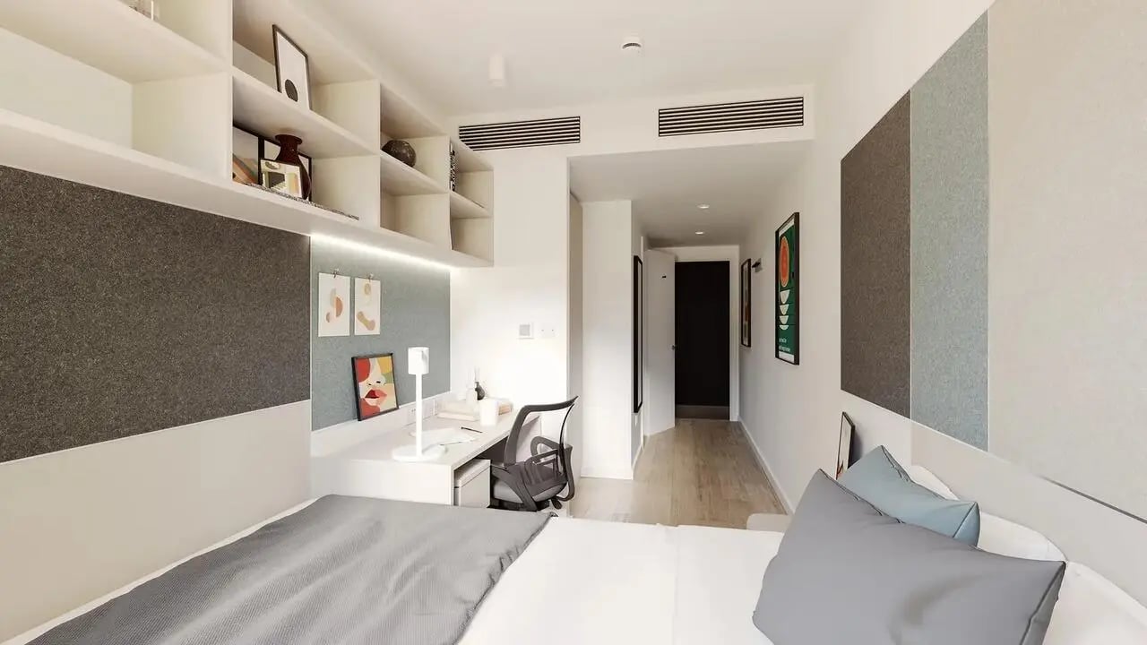 Bed desk shelving and doorway bedroom at Signal House in London Student Accommodation