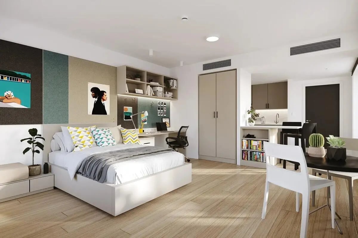 Bed desk chair kitchen and dining area bedroom at Signal House in London Student Accommodation
