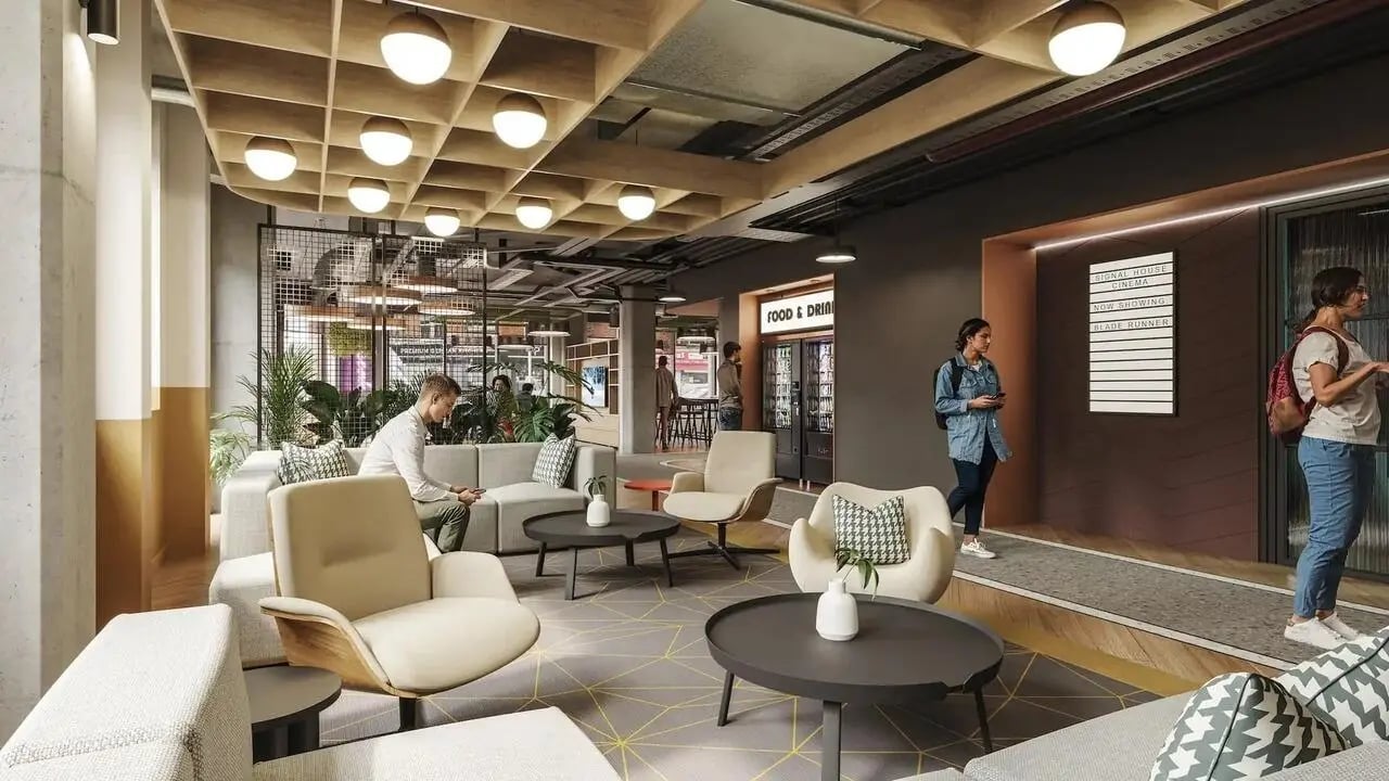 Modern communal lounge with seating and food vending machine communal area at Signal House in London Student Accommodation