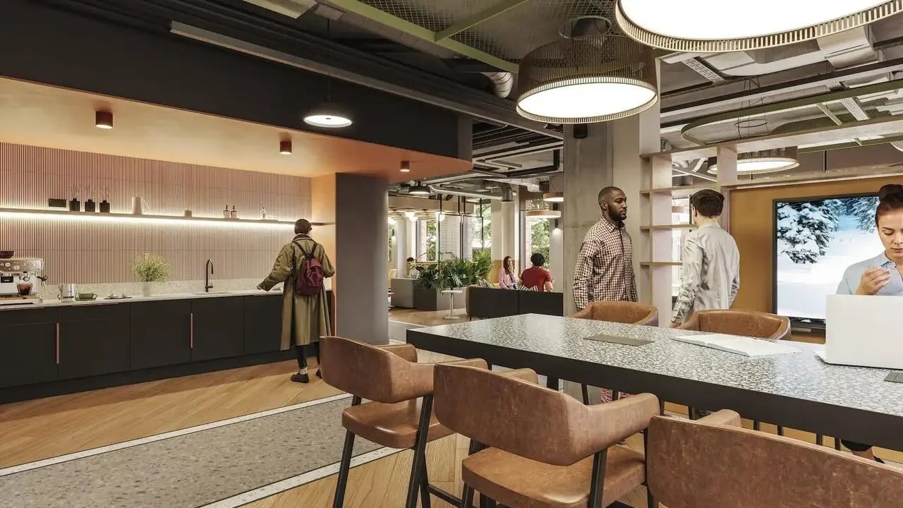 Kitchen area with bar stools and communal dining table at Signal House in London Student Accommodation
