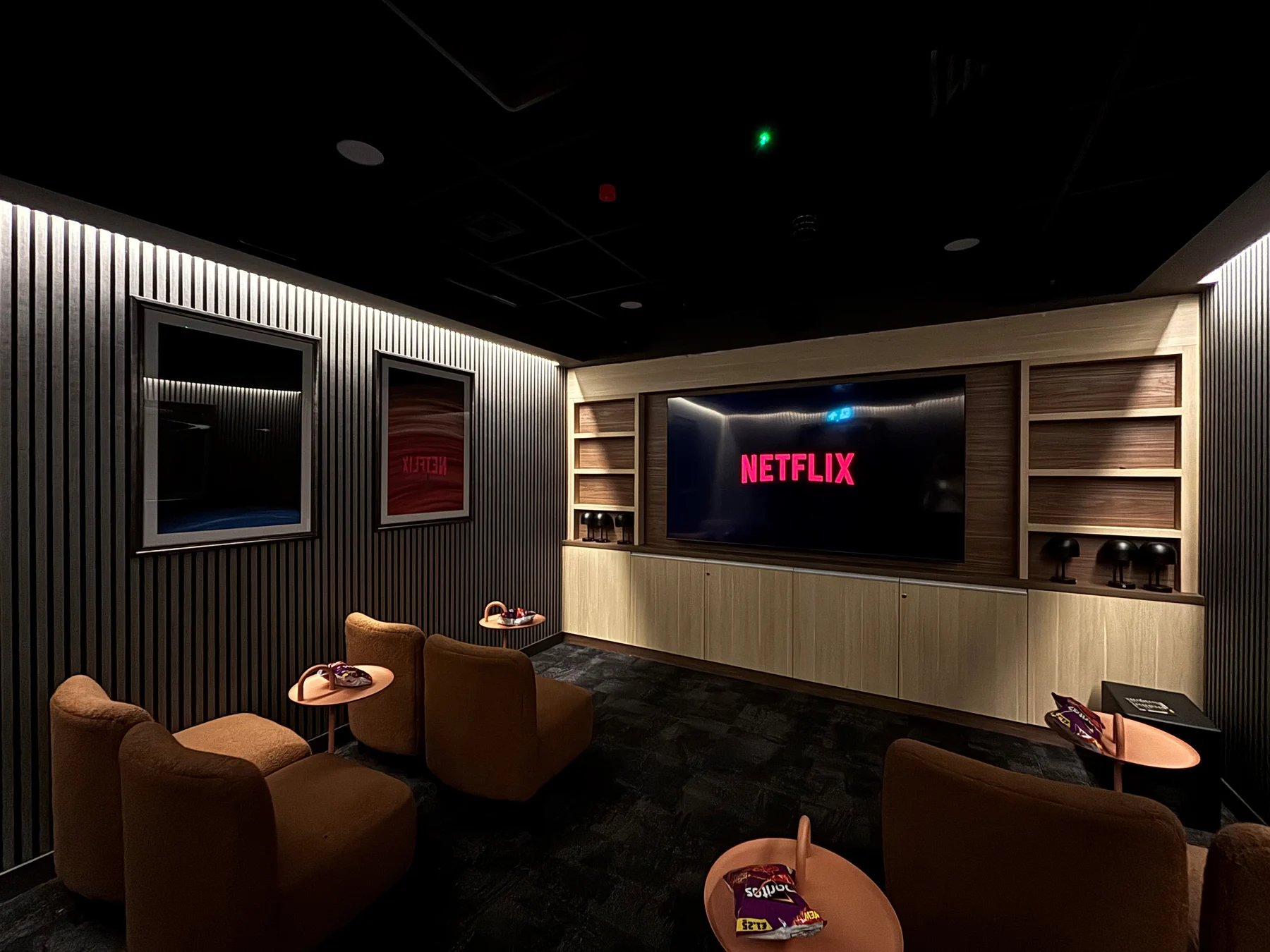 Netflix screen with chairs and tables communal area at The Port On The Square in Bristol Student Accommodation