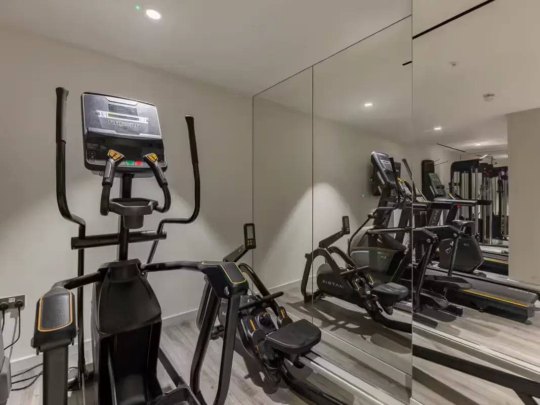 Elliptical rower and treadmills mirrored gym area at Grosvenor House in London Student Accommodation