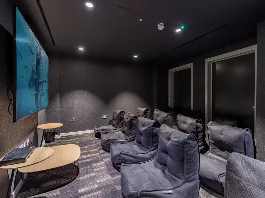 Beanbag chairs and tables in a cinema room at Grosvenor House in London Student Accommodation