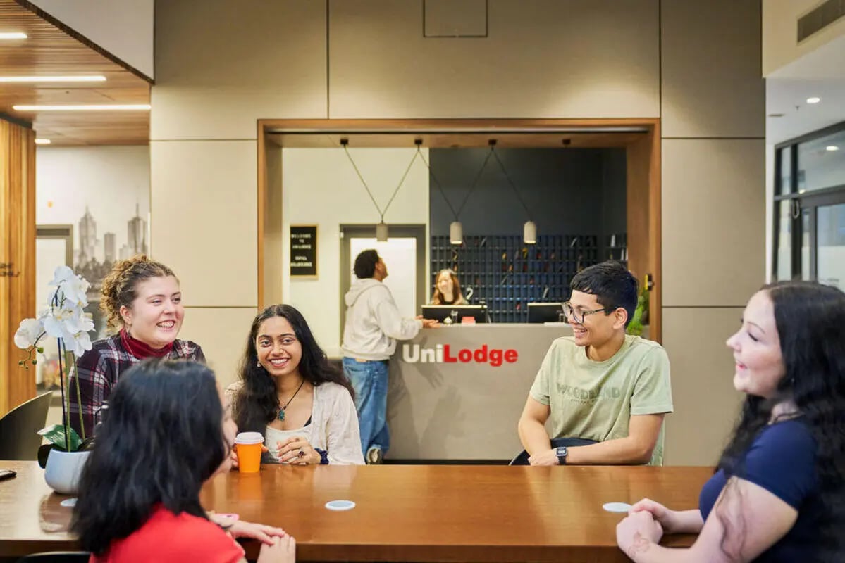 Students chatting at a reception desk common room at UniLodge Royal Melbourne in Melbourne Student Accommodation
