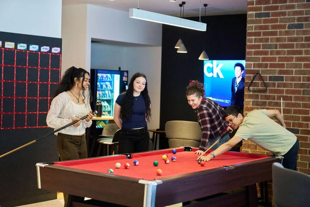 Students playing pool at a table living room at UniLodge Royal Melbourne in Melbourne Student Accommodation