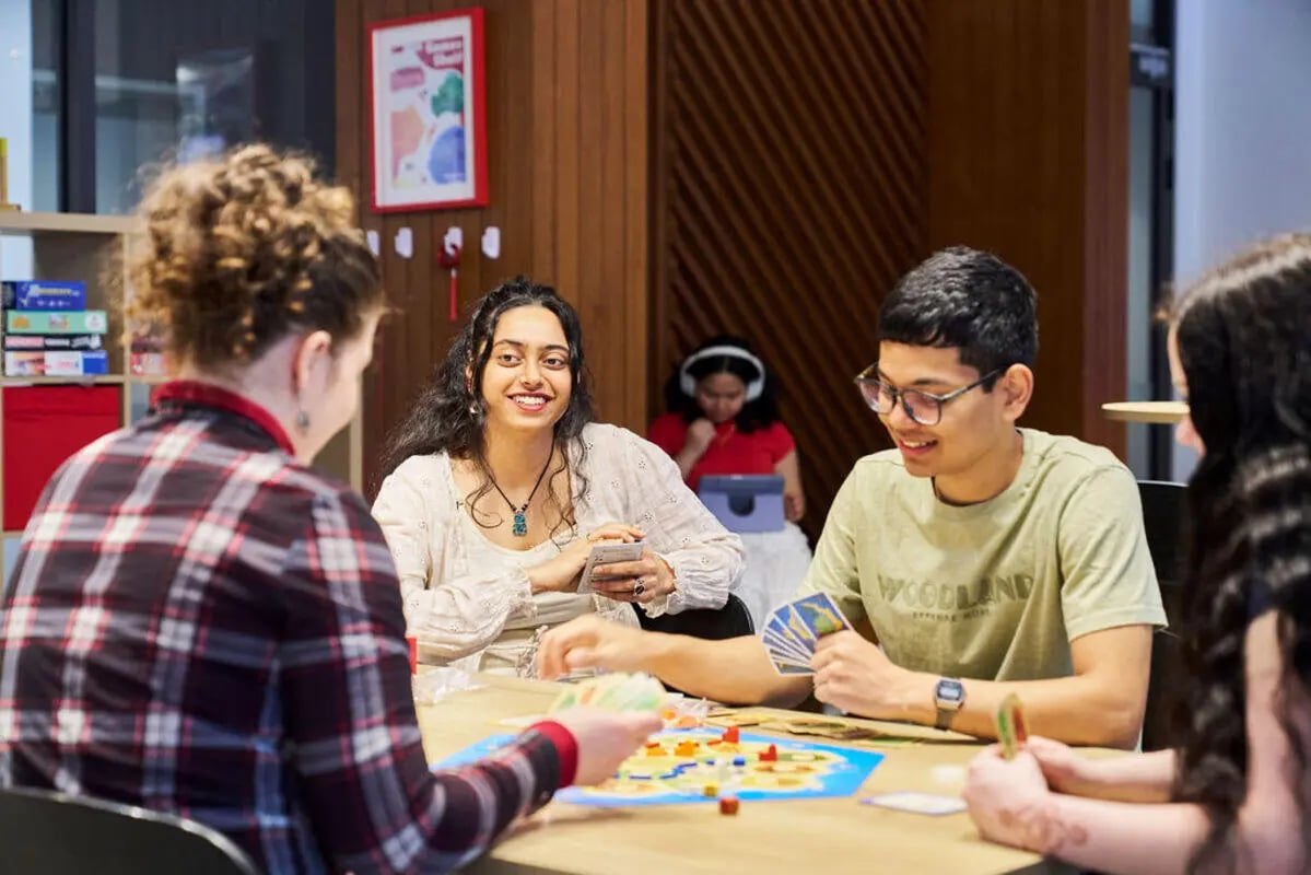 Students playing board games at a table playing area at UniLodge Royal Melbourne in Melbourne Student Accommodation