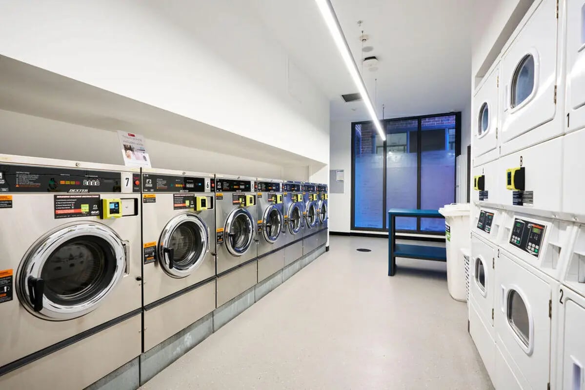 Washing machines and dryers in student laundry room at UniLodge Royal Melbourne in Melbourne Student Accommodation