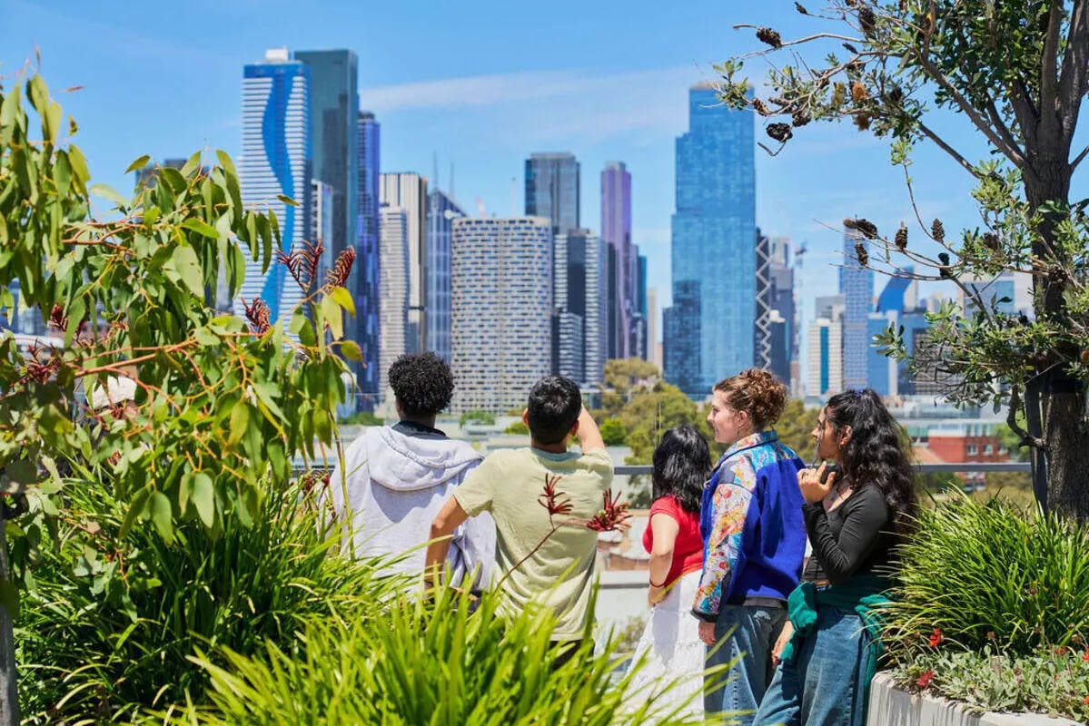 Students viewing city skyline from rooftop exterior at UniLodge Royal Melbourne in Melbourne Student Accommodation