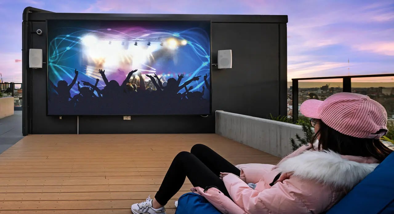 Outdoor screen concert crowd and girl watching living room at UniLodge Royal Melbourne in Melbourne Student Accommodation