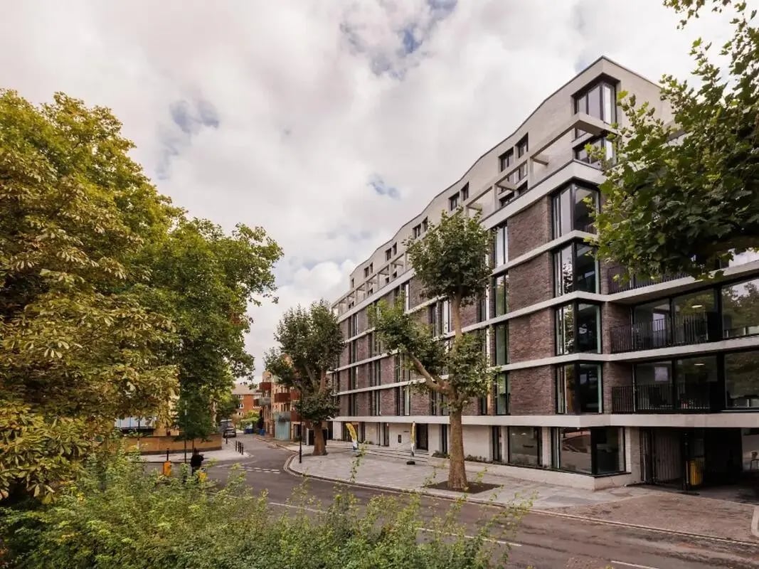 Modern brick building with balconies and trees exterior at Element Bermondsey in London Student Accommodation