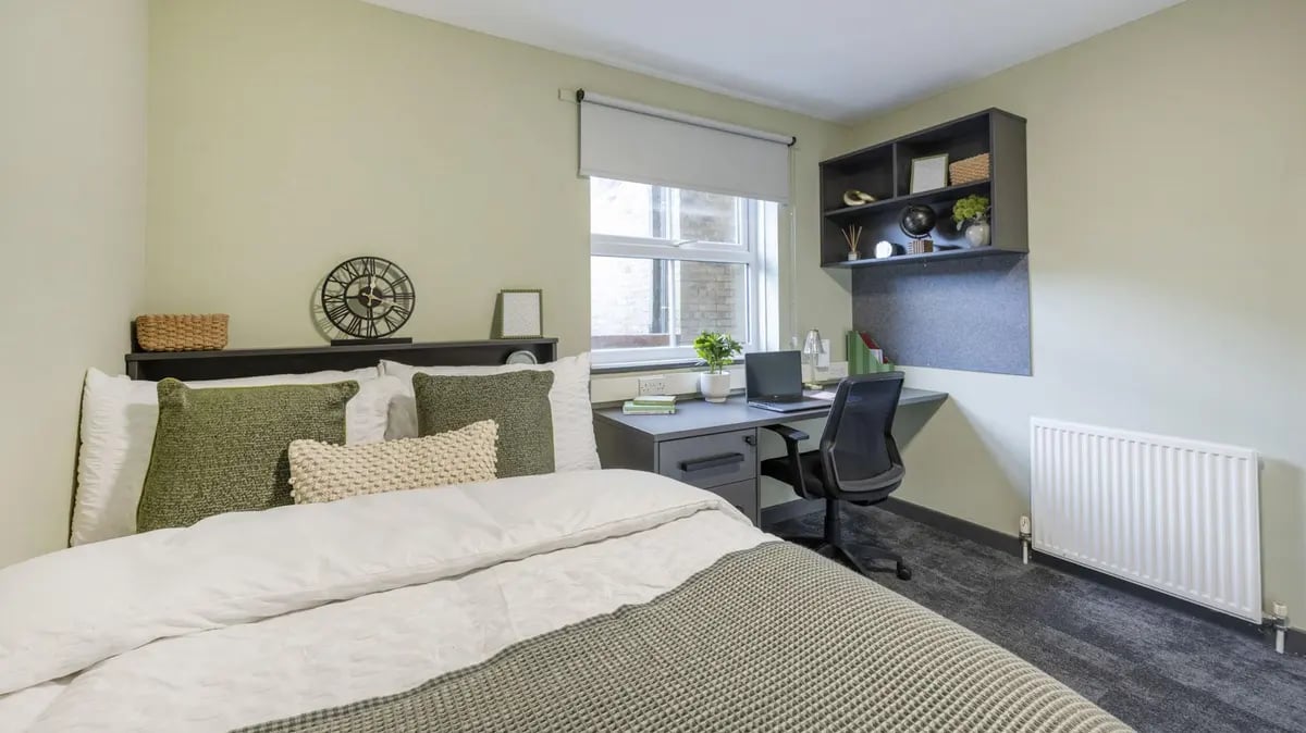 Bed desk shelving and clock Bedroom at Dean House in London Student Accommodation