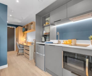 Kitchenette with study desk and bed bedroom at Iconinc The Bonnie in Glasgow Student Accommodation