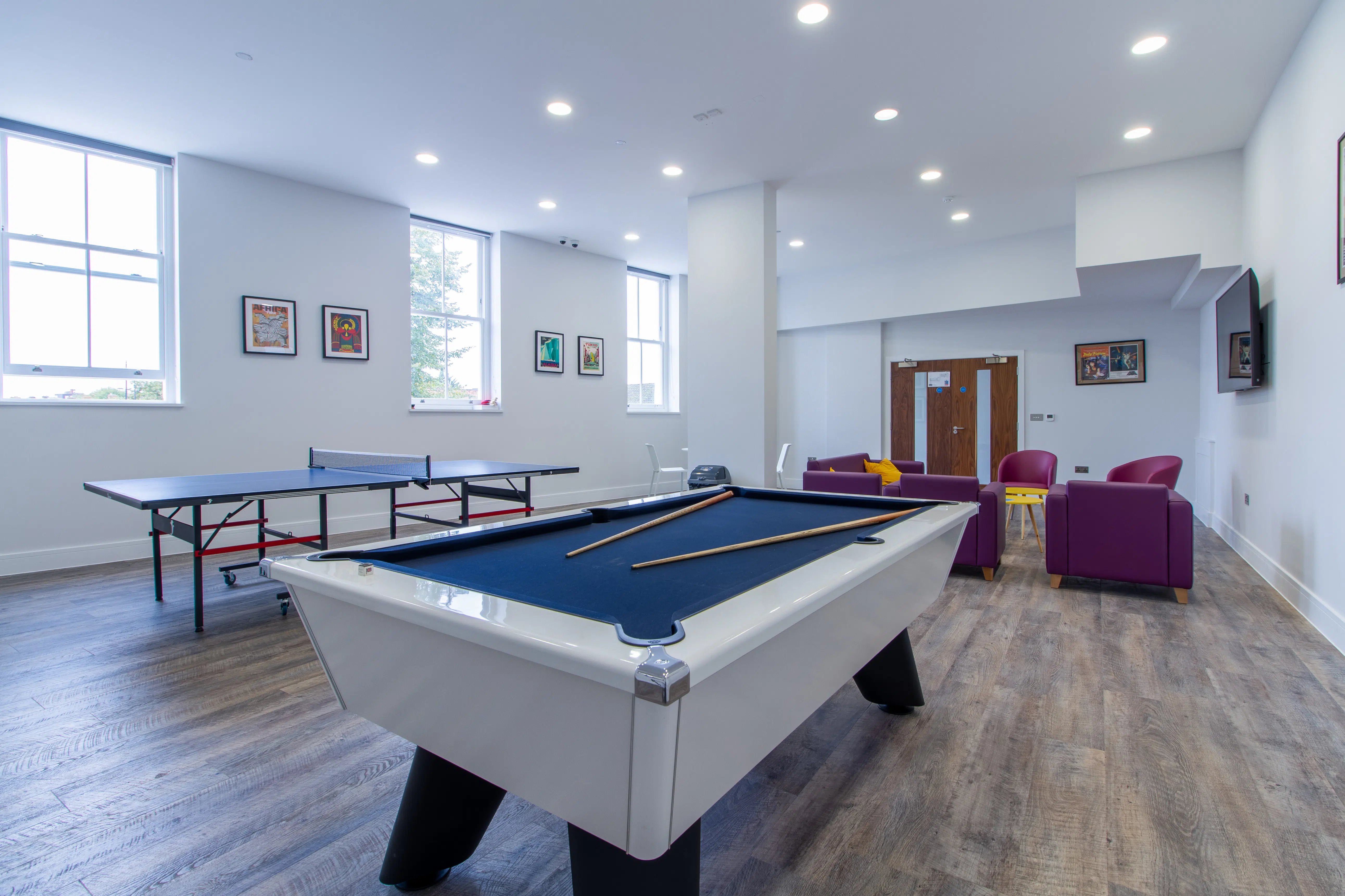 Pool table ping pong table purple chairs living area at AXO Seven Sisters in London Student Accommodation