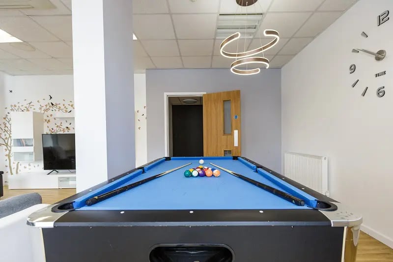Pool table with cues and balls recreation area at AXO Islington in London Student Accommodation