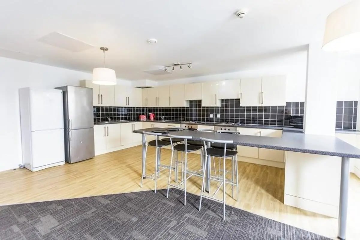 Kitchen with counter and stools kitchen area at AXO Islington in London Student Accommodation