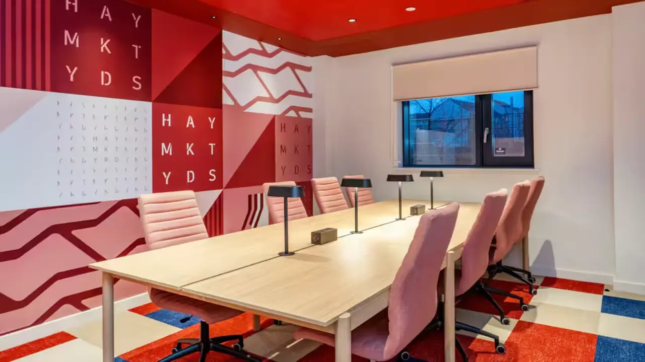 Study area with long table pink chairs and lamps at Haymarket Yards in Edinburgh Student Accommodation