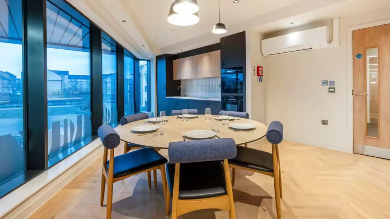 Round table with chairs kitchen and window area at Haymarket Yards in Edinburgh Student Accommodation