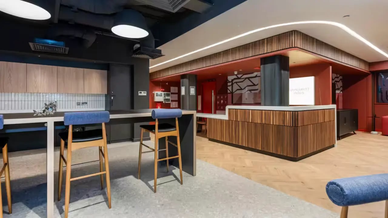 Bar stools at counter with kitchen and reception area at Haymarket Yards in Edinburgh Student Accommodation