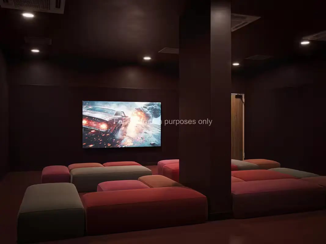 Large screen showing car explosion with floor cushions playing area at St Vincent Studios in Glasgow Student Accommodation