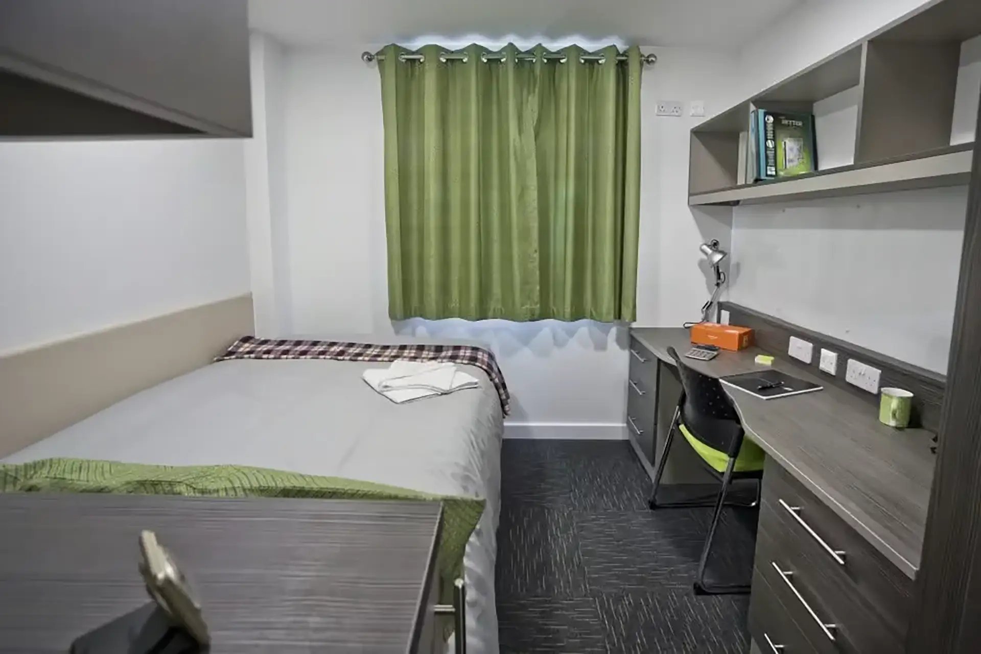 Bed desk lamp shelves and chair bedroom study area at Friargate Court in Preston Student Accommodation