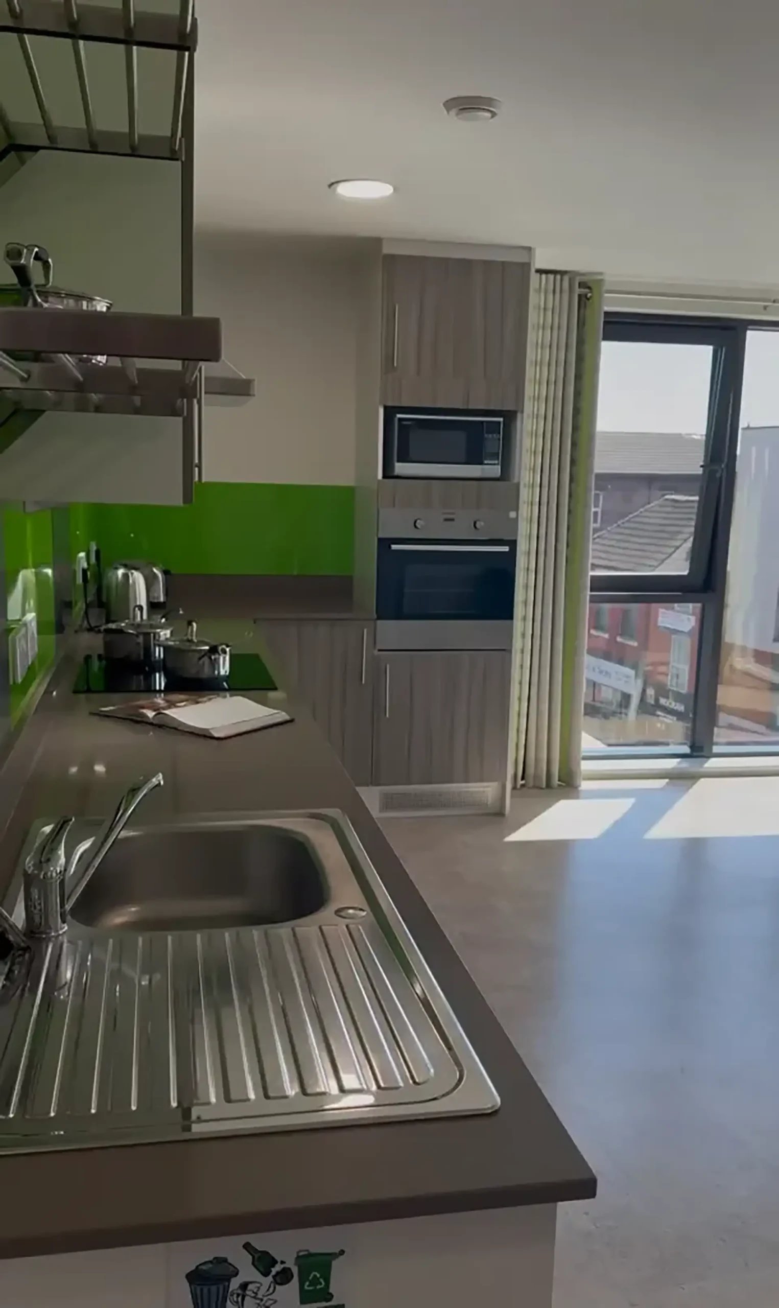 Sink hob microwave oven and cabinets kitchen at Friargate Court in Preston Student Accommodation