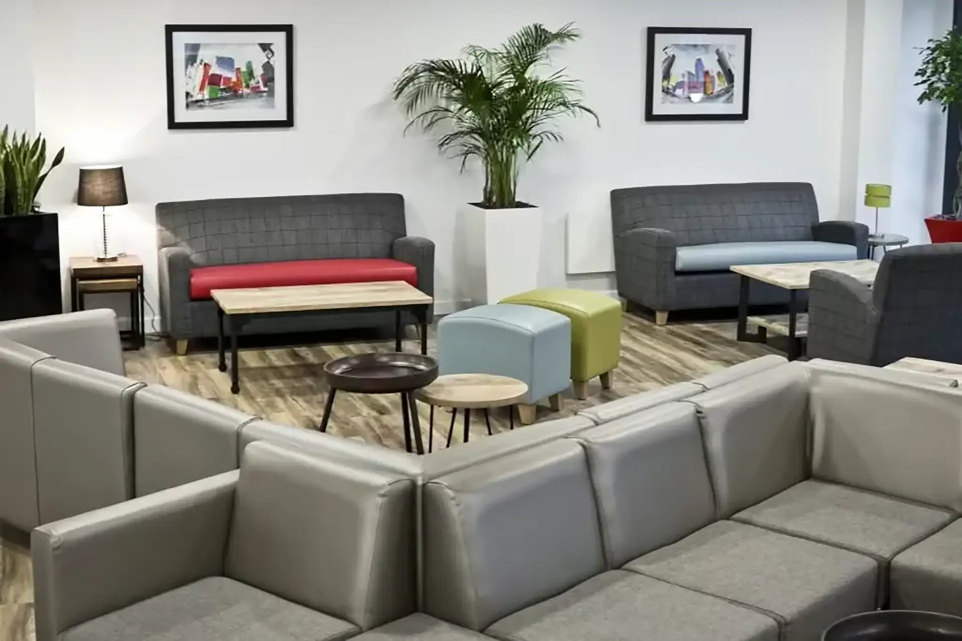 Sectional sofas, plant, ottomans, pictures, tables lounge area at Friargate Court in Preston Student Accommodation