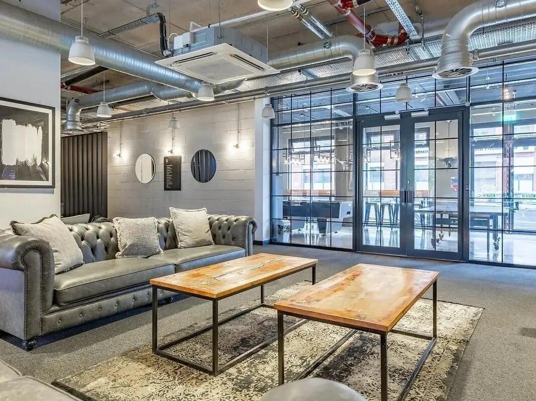 Chesterfield sofa coffee tables patterned rug living room at Globe Works in Birmingham Student Accommodation