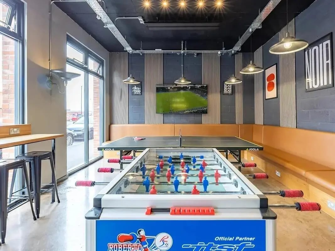 Foosball table ping pong table sofa television playing area at Globe Works in Birmingham Student Accommodation