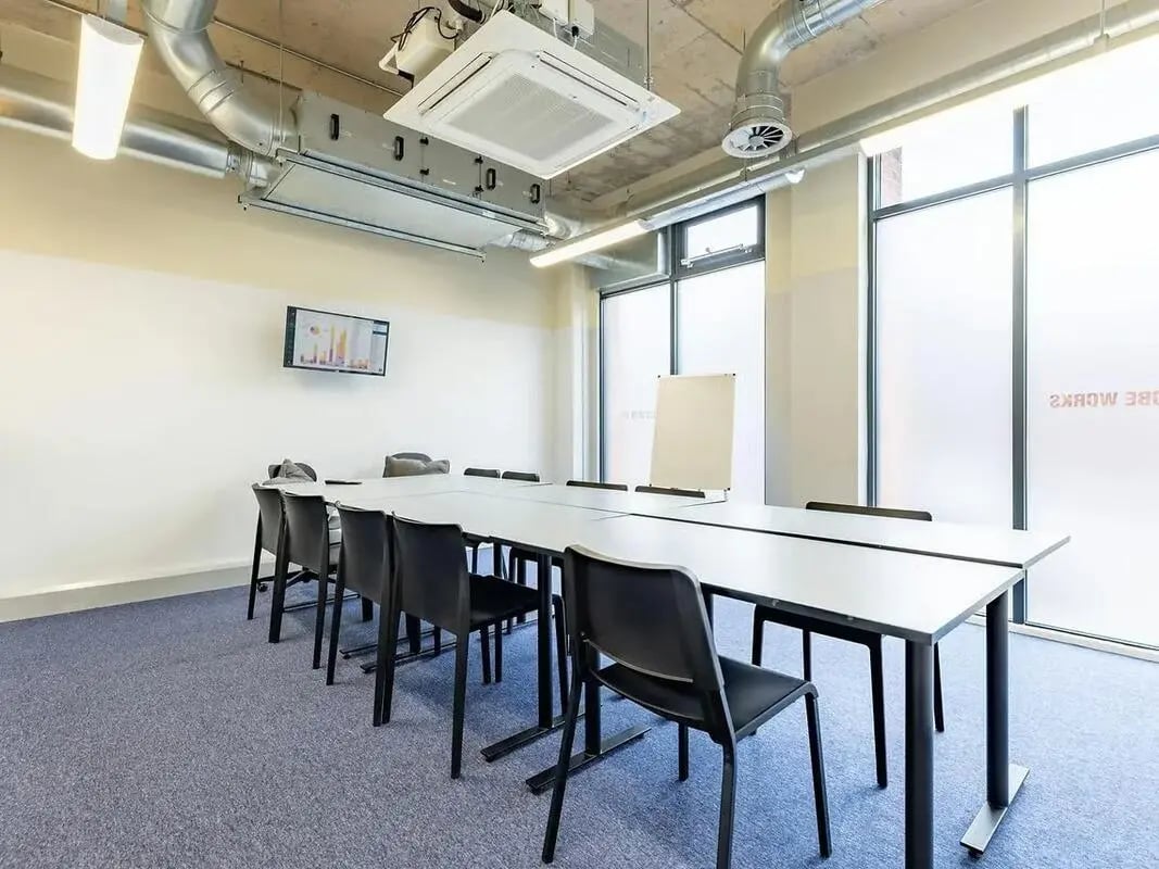 Conference table chairs whiteboard screen meeting room at Globe Works in Birmingham Student Accommodation