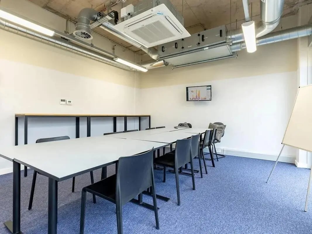 Long table with chairs whiteboard screen study area at Globe Works in Birmingham Student Accommodation