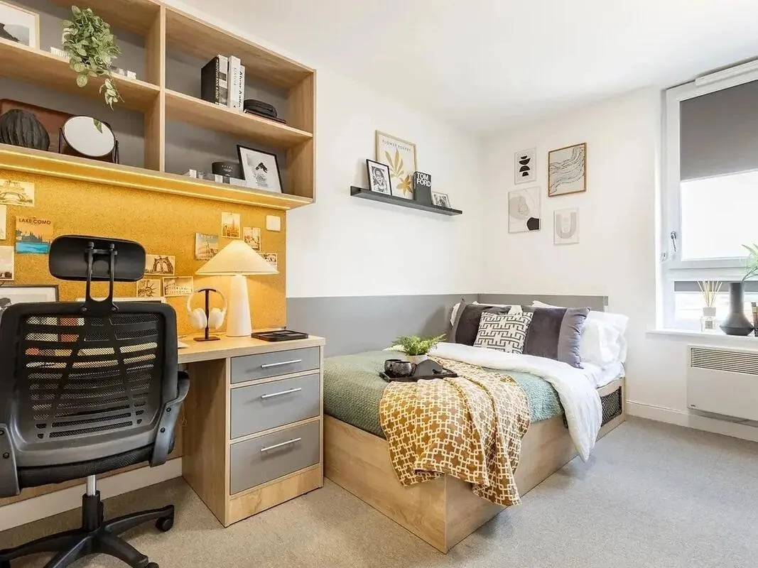 Desk chair bed shelves and cork board bedroom at Globe Works in Birmingham Student Accommodation