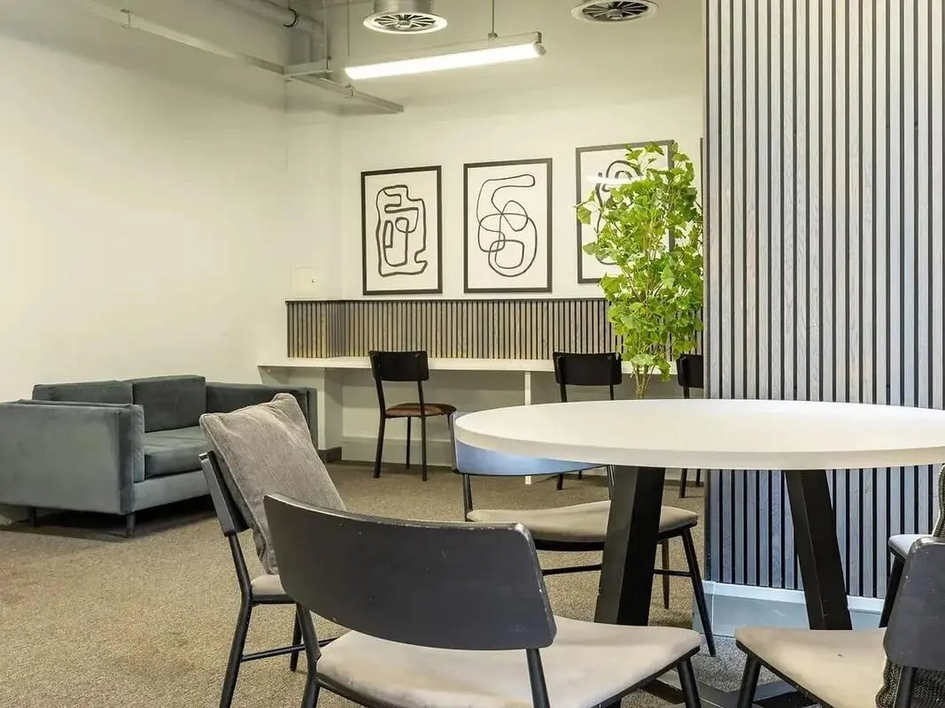 Sofa table chairs artwork plant lounge area at Globe Works in Birmingham Student Accommodation