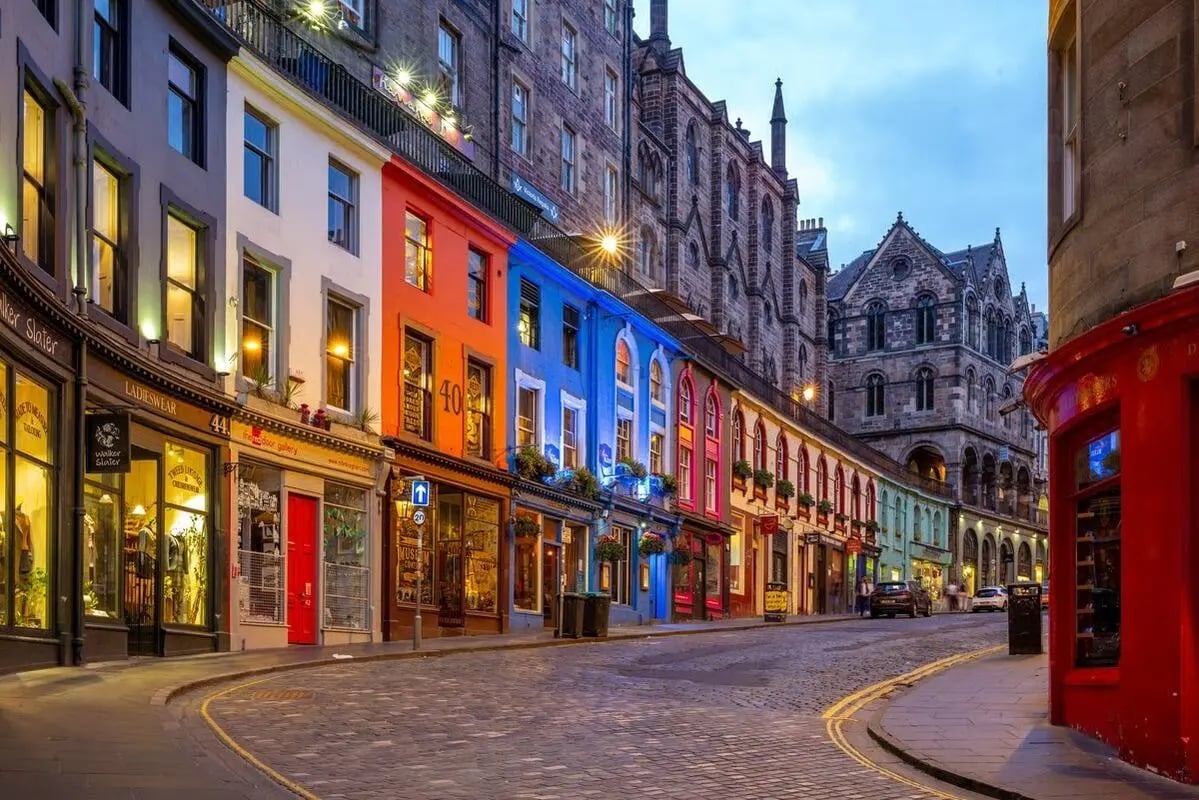 Colorful buildings with shops line a cobblestone street exterior at Straits Mile in Edinburgh Student Accommodation