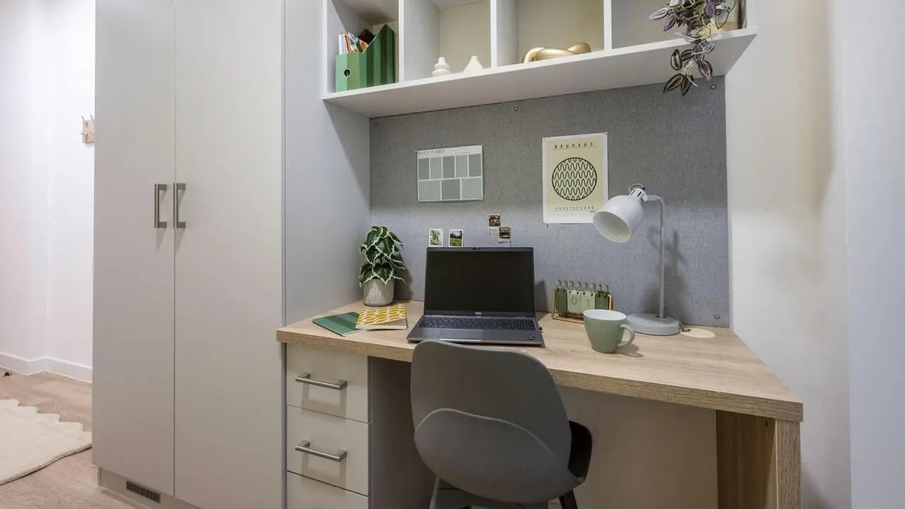 Desk laptop plant and chair study area at St Gabriels in Manchester Student Accommodation