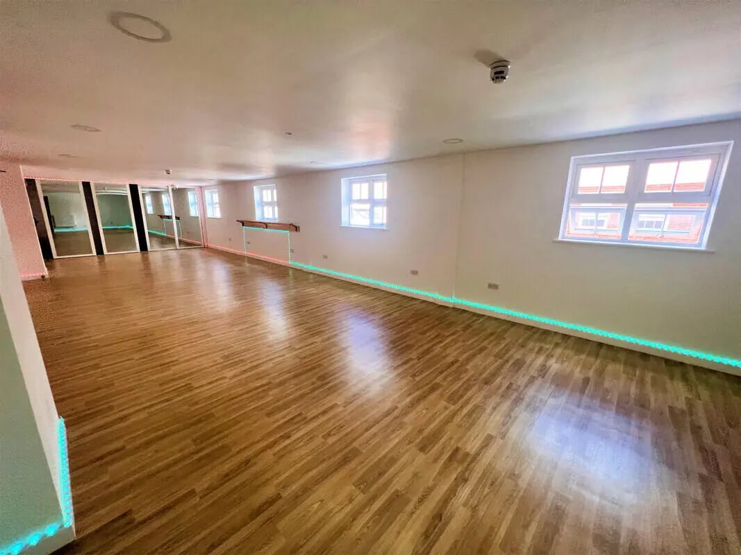 Mirrored wall wooden floor large open room living area at Tudor Studios in Leicester Student Accommodation