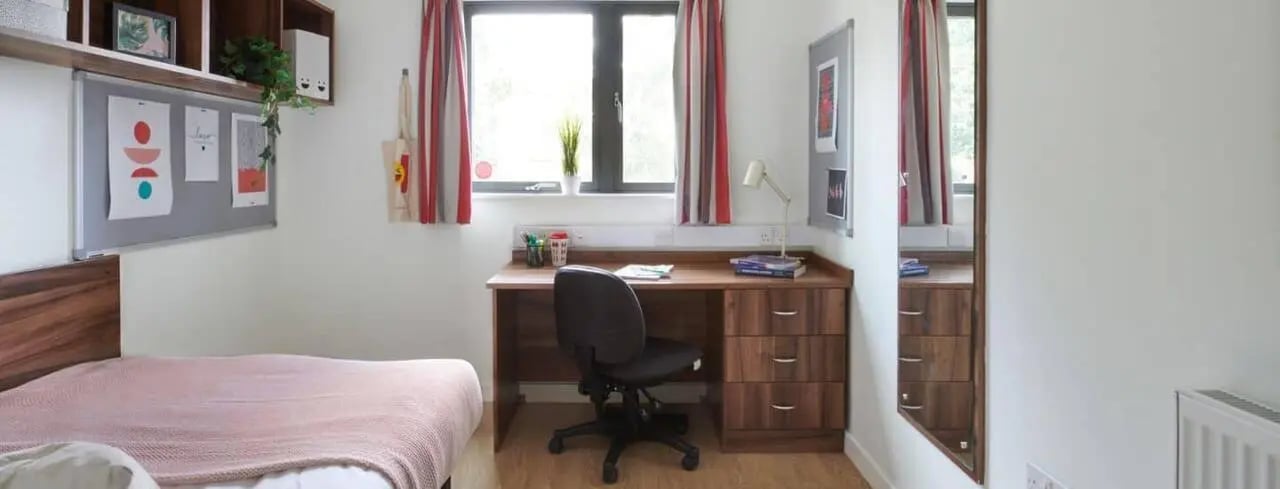 Bed desk chair mirror and artwork student bedroom at The Printworks in Exeter Student Accommodation
