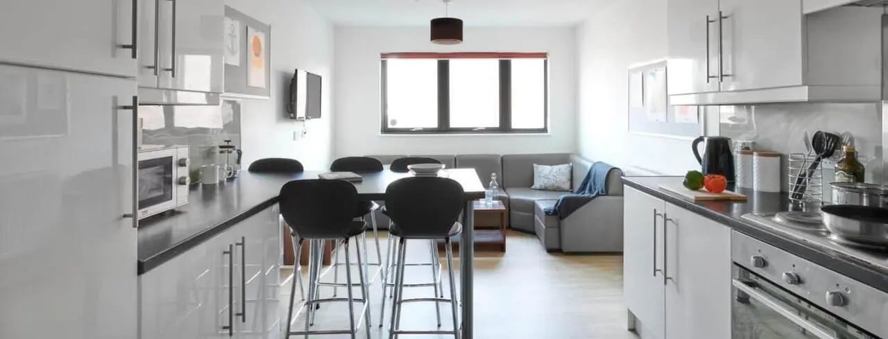 Modern kitchen with dining area and sofa Living room at The Printworks in Exeter Student Accommodation